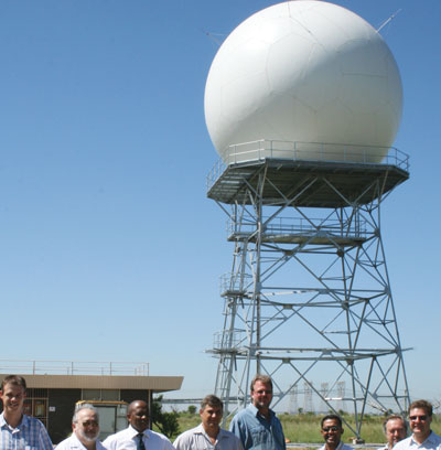 Recently commissioned at Irene, Gauteng, the first of 10 long range weather radar installations for SAWS, with the project team in the foreground. (Left to right) Marco Lammerding (SAAB), Simon Lechtman (SSI), Eric Tshwele (SSI), Hennie Austin (SAAB), Koos van der Merwe (SAAB), Georgie George (SAWS), Jan Blackie (SAWS) and Ernst Vermeulen (SAAB)